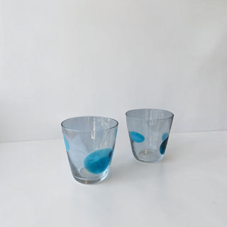 Her Good Eye set of two hand-blown clear glass tumblers featuring organic blue and navy spots.