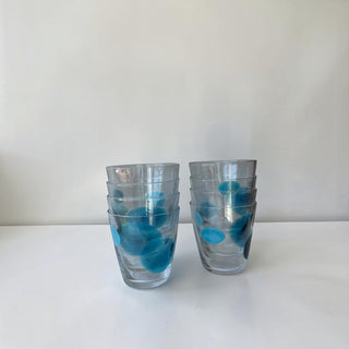 Her Good Eye hand-blown glass tumblers with blue and navy organic spots in two stacked sets on a white surface.