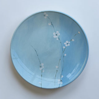 Her Good Eye hand-painted ceramic dinner plate with sky-blue glaze and white cherry blossoms.