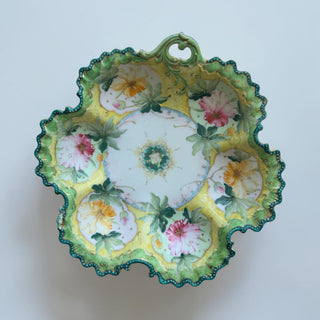 Her Good Eye hand-painted porcelain serving bowl with floral motifs, scalloped emerald green rim, and gold detailing.