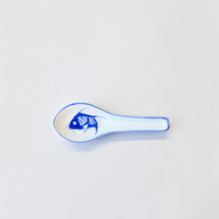 Her Good Eye blue and white ceramic spoon rest featuring a hand-painted koi fish motif on a white background.