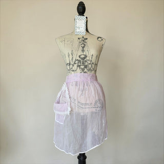 Her Good Eye sheer lavender half apron with white lace trim and pocket. Adjustable tie waist.