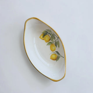 Her Good Eye white ceramic serving dish with lemon branch motif and gold rim. Oval shape, perfect for appetizers or decor.