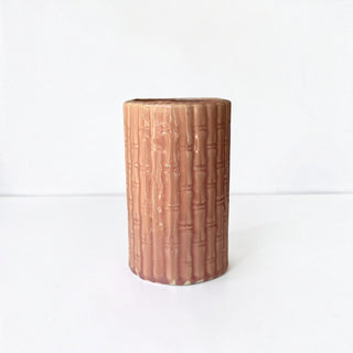 Her Good Eye mauve-pink ceramic cylinder vase with a textured bamboo pattern and glossy finish.