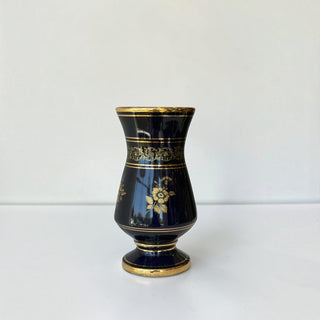 Her Good Eye midnight blue porcelain tabletop vase featuring intricate gold-leaf floral motifs and ornate gilded bands.