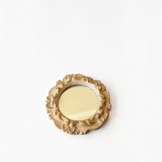 Her Good Eye round wall mirror with an ornate scalloped frame in a distressed gold finish for vintage home decor.