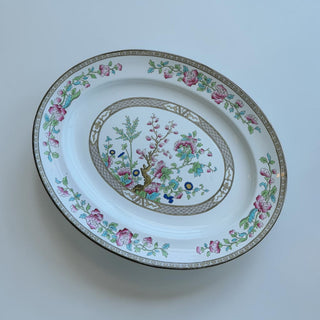 Her Good Eye oval porcelain serving platter with pink and blue floral Chinoiserie design and Greek key border.