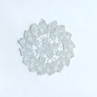 Her Good Eye vintage-inspired round lace doily in pale blue with an intricate floral-inspired openwork design.