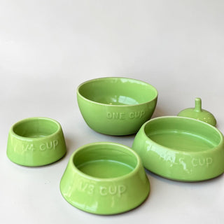 Her Good Eye green ceramic pear-shaped measuring cups set with embossed measurements.