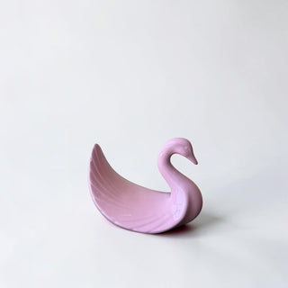 Her Good Eye pink ceramic swan dish with glossy finish and fanned tail detail. Ideal for trinkets or decor.