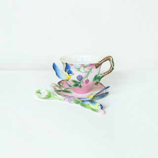 Her Good Eye porcelain tea cup and saucer set in pastel pink with 3D blue tit bird, berry motif, and branch handle.