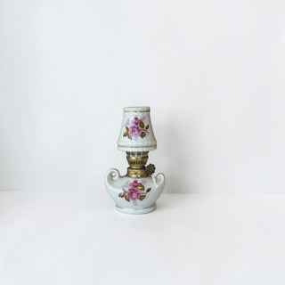 Her Good Eye vintage porcelain oil lamp with pink rose floral pattern and antique brass burner for cottagecore decor.
