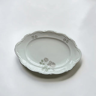 Her Good Eye vintage oval porcelain serving platter with white finish, scalloped edges, and muted rose floral motifs.