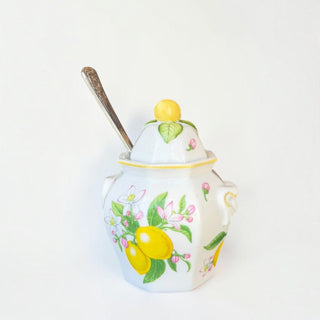 Her Good Eye porcelain sugar bowl with a hand-painted lemon and citrus blossom motif, lid, and silver serving spoon.