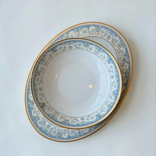 Her Good Eye decorative porcelain serving bowl with blue floral pattern and gold rim. Ideal for serving dishes.
