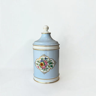 Her Good Eye powder blue porcelain apothecary jar with hand-painted floral motif and gold-tone gilded rim details.