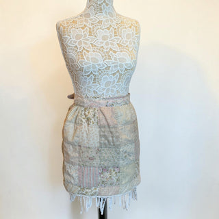 Her Good Eye vintage quilted patchwork waist apron in pastel floral and gingham patterns with a fringed hem.