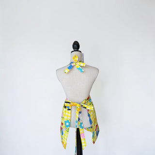 Her Good Eye yellow gingham Raggedy Ann & Andy apron with floral accents and adjustable ties.