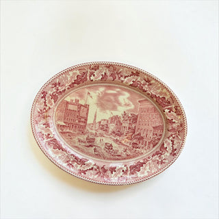 Her Good Eye vintage oval ceramic serving platter with deep red transferware cityscape and oak leaf border.