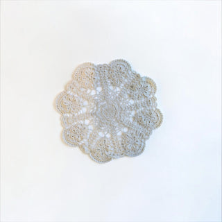 Her Good Eye handmade round crochet lace doily with intricate floral patterns in a soft neutral beige thread