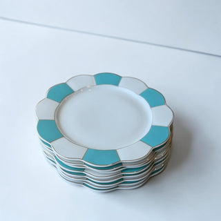 Her Good Eye scalloped edge white ceramic dinner plate with turquoise geometric design and gold rim.