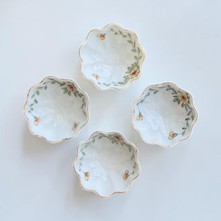 Her Good Eye scalloped porcelain trinket dish with yellow and orange floral design and gold trim.
