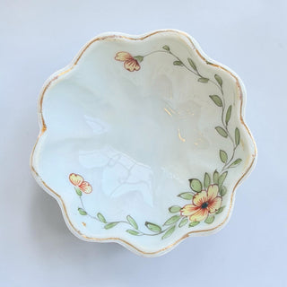 Her Good Eye scalloped porcelain trinket dish with hand-painted yellow and orange flowers, green leaves, and gold trim.