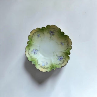 Her Good Eye vintage porcelain bowl with scalloped edges, green wash, violet floral motifs, and gold-toned detailing.