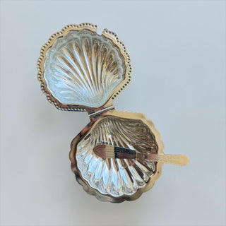 Her Good Eye decorative silver-tone metal shell-shaped butter dish with glass insert and ornate butter knife.