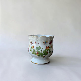 Her Good Eye porcelain planter with strawberry and butterfly pattern, scalloped rim with gold trim, and pedestal base.