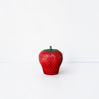Her Good Eye decorative red ceramic strawberry lidded container with green stem detail on a white background.