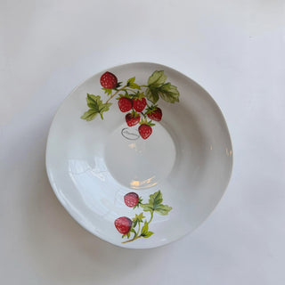 Her Good Eye white ceramic serving bowl with a strawberry pattern and green leaves.