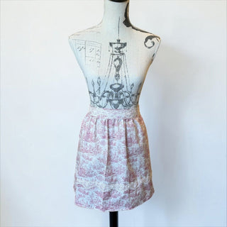 Her Good Eye vintage-inspired cotton half apron with dusty rose toile print, lace trim, and gathered waist on mannequin