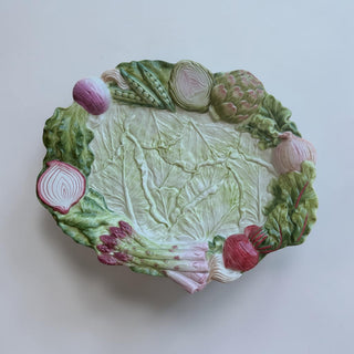 Her Good Eye vegetable garden ceramic serving platter shaped like cabbage with asparagus, artichokes, peas, onions, and beets.