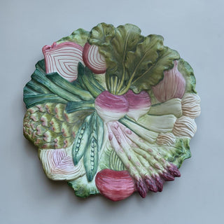 Her Good Eye Vegetable Medley decorative ceramic plate with asparagus, peas, radishes, turnips, onions, and lettuce.