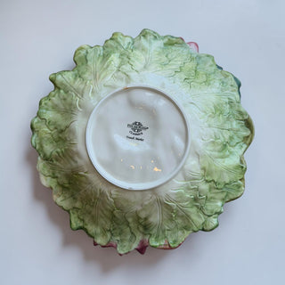 Her Good Eye Vegetable Medley decorative ceramic plate with lettuce leaf design and painted vegetables.