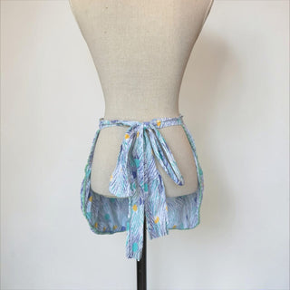 Her Good Eye vintage half apron with abstract brushstrokes and polka dots in blue, purple, yellow, and green. Tie waist.