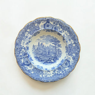 Her Good Eye vintage blue and white porcelain soup bowl with pastoral landscape and gold-trimmed scalloped edges.