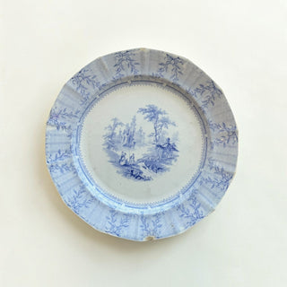 Her Good Eye vintage blue and white ceramic transferware dinner plate with a pastoral scene and scalloped edge.