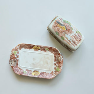 Her Good Eye vintage ceramic butter dish and tray with scenic landscape and floral border in brown, ochre, and green.