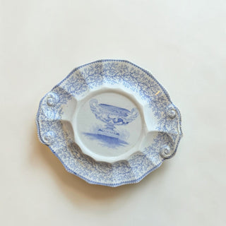 Her Good Eye vintage ceramic serving plate with blue and white floral transferware, urn motif, and scalloped edges.