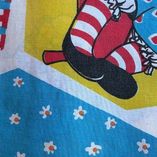 Her Good Eye vintage cotton fabric featuring a whimsical character with red striped stockings and daisy floral print.