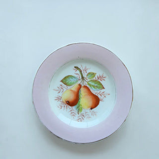 Her Good Eye vintage porcelain plate with hand-painted pear motif and soft pink border on a white background.