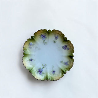 Her Good Eye vintage porcelain serving plate with scalloped edges, sage green wash, and hand-painted violet flowers.
