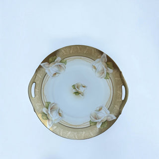 Her Good Eye vintage porcelain serving platter with white rose floral motifs, gold scrollwork border, and side handles.