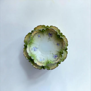 Her Good Eye vintage porcelain serving plates with scalloped edges, sage green wash, and hand-painted violet flowers.