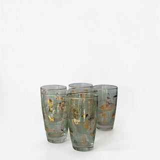 Her Good Eye vintage highball glasses with seafoam green net pattern and gold seashell and marine life illustrations.