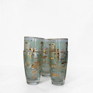 Her Good Eye vintage highball glasses with seafoam green net pattern and gold seashell and marine life illustrations.