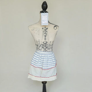 Her Good Eye vintage-style cotton waist apron with blue stripes and red ric-rac trim on a dress form mannequin.
