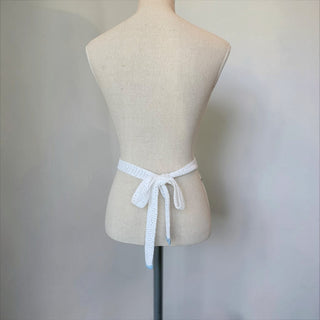 Her Good Eye white crocheted mini skirt with decorative trim and tie-back closure. Cotton blend.